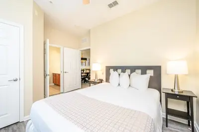 a bedroom with a large white bed with white pillows at Epic Universe New Beautiful Condo, Vista Cay, Orlando - 3011 in Orlando