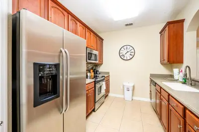 a kitchen with a stainless steel refrigerator at Epic Universe New Beautiful Condo, Vista Cay, Orlando - 3011 in Orlando
