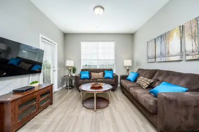 a living room with a couch and a table at Epic Universe Beautiful Lakeview Condo, Vista Cay Orlando - 3013 in Orlando