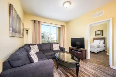 a living room with a couch and a tv at Beautiful Deluxe Condo, Vista Cay - 3015 in Orlando