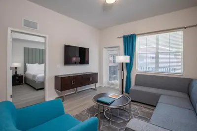 a living room with a couch and a tv at New Modern Vista Cay Reserve Condo - 6007 in Orlando