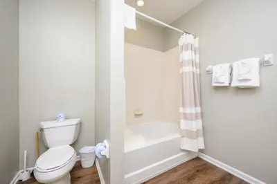 a bathroom with a toilet and a tub and a shower at Epic Universe New Modern Townhome, Near The Parks - 4029 in Orlando