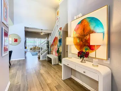 a living room with a large painting on the wall at WH7820BS - 5 bedrooms - Pool - Theater - Resort in Orlando