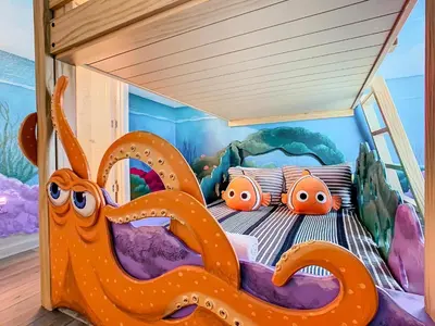 a bedroom with a bed with an octopus on it at WH7820BS - 5 bedrooms - Pool - Theater - Resort in Orlando