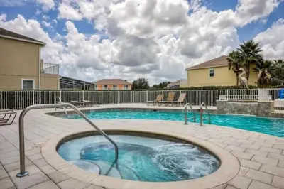 a large swimming pool with a hot tub at Pond view pool home close to Disney TR17508PA - 3 bedrooms - 3 bath - waterview in Orlando