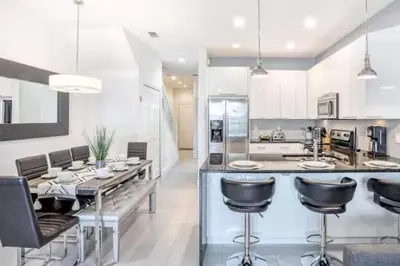 a kitchen with a large island with bar stools at Pond view pool home close to Disney TR17508PA - 3 bedrooms - 3 bath - waterview in Orlando