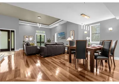 a dining room and living room with a table and chairs at Summer Days Fun - Renovated TownHome by Disney! in Orlando