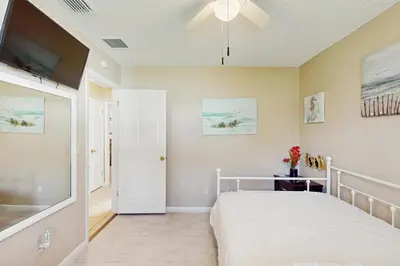a bedroom with a bed and a flat screen tv at Pool Access! Dog-Friendly Retreat 16 Mi to Orlando in Orlando