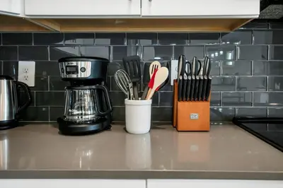 a kitchen counter with knives and utensils on it at Magical Mickey Home 8 minutes from Disney STL109 in Kissimmee
