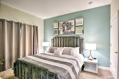 a bedroom with a large bed and two lamps at The Windermere - Pool Lazy River & Waterslides in Kissimmee