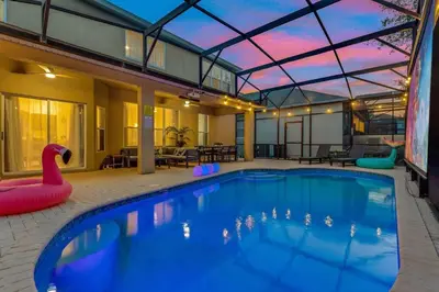 a large swimming pool with an inflatable pool toy in a house at Immersive Themed Villa in Resort 4mi to Disney with Game Room and Private Pool in Orlando