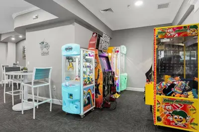 a room with many games and a table and chairs at Immersive Themed Villa in Resort 4mi to Disney with Game Room and Private Pool in Orlando