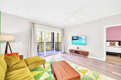 a living room with a couch and a table at Modern 3BR Condo Near Disney- Pool in Orlando