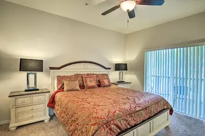a bedroom with a bed and a ceiling fan at Quiet Disney Condo w/ Balcony ~ 2 Miles to Disney World! in Orlando