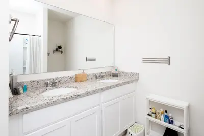 a bathroom with two sinks and a large mirror at Entire House close to Disney in Orlando