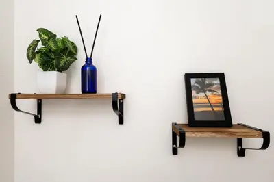a shelf with a picture and a vase on a wall at Entire House close to Disney in Orlando