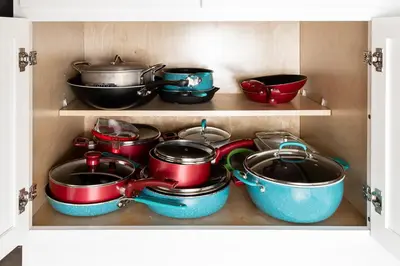 a drawer filled with pots and pans in a kitchen at Entire House close to Disney in Orlando
