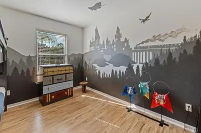a bedroom with a wall mural of a castle at Enjoyable 6BR Home Near Disney in Orlando