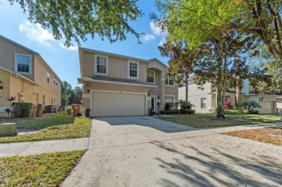 a house with a driveway and a garage at Enjoyable 6BR Home Near Disney in Orlando
