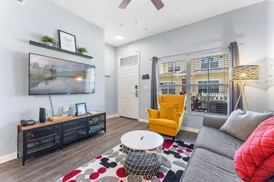 a living room with a couch and a yellow chair at Mickey's Magical Townhome Venetian Bay Villages in Kissimmee
