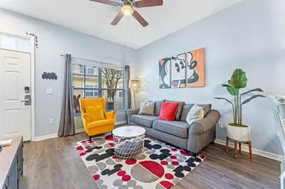a living room with a couch and a chair at Mickey's Magical Townhome Venetian Bay Villages in Kissimmee