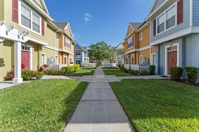 a sidewalk in front of a row of houses at Mickey's Magical Townhome Venetian Bay Villages in Kissimmee