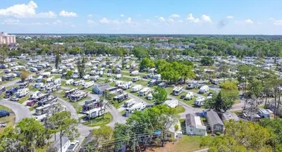 an aerial view of a parking lot with parked cars at Sherwood Forest Mobile Home in Kissimmee