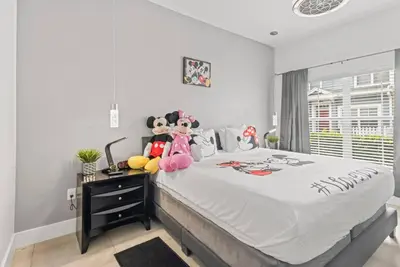 a bedroom with a large bed with stuffed animals on it at The Villas at Seven Dwarfs - 2603 Amazing Luxury Villa - Near Disney - Water Park in Kissimmee