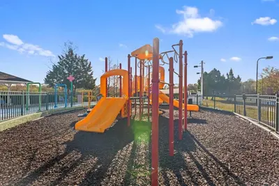 a playground with an orange slide in a park at The Villas at Seven Dwarfs - 2603 Amazing Luxury Villa - Near Disney - Water Park in Kissimmee