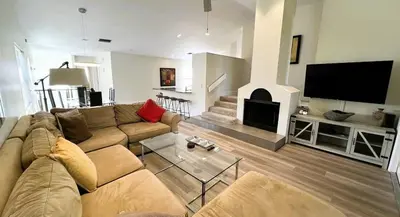 a living room with a couch and a fireplace at Stunning Ventura Condo in Orlando