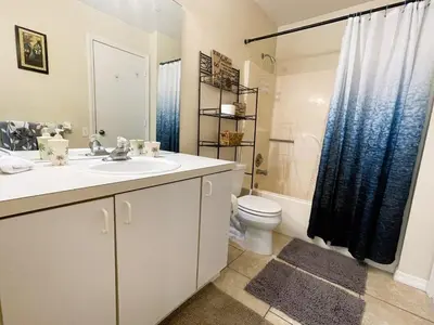 a bathroom with a sink and a toilet and a shower at Ventura Village Cottage Grove Townhome in Orlando