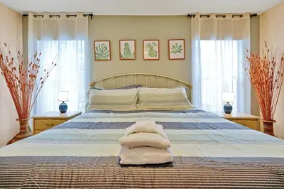 a bedroom with a bed with towels on it at Minutes from Disney - Entertainment Haven with Pool in Orlando