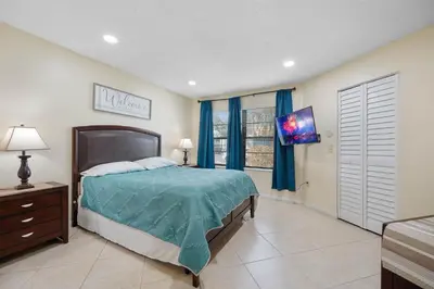 a bedroom with a bed and a television in it at 3608 Orlando Vacational 1st floor in Orlando