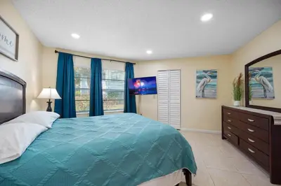 a bedroom with a blue bed and a window at 3608 Orlando Vacational 1st floor in Orlando