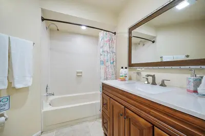 a bathroom with a sink and a tub and a mirror at 3608 Orlando Vacational 1st floor in Orlando