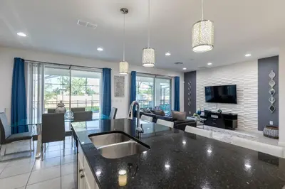 a kitchen with a sink and a living room at Beautiful and cozy home at Sonoma Resort in Kissimmee