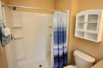 a bathroom with a shower curtain and a toilet at Perfect vacation Gated Resort with Private Pool in Kissimmee