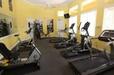a gym with several exercise bikes in a room at Perfect vacation Gated Resort with Private Pool in Kissimmee