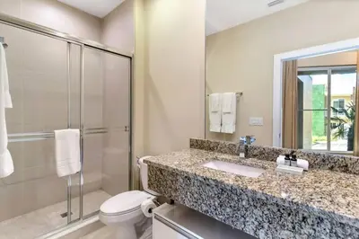 a bathroom with a sink and a toilet and a shower at Magical Disney Home (45366427) in Orlando