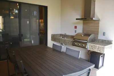 a kitchen with a wooden table and a counter top at Fantasy Disney Home (45858326) in Orlando