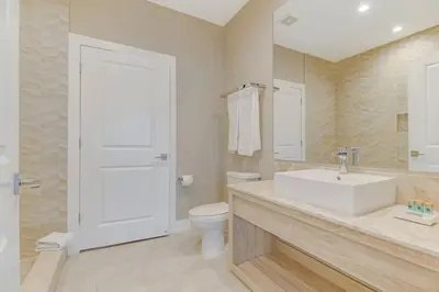 a white bathroom with a sink and a toilet at Fantasy Disney Home (45858326) in Orlando
