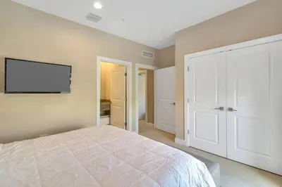 a bedroom with a bed and a flat screen tv at wish home disney (45437492) in Orlando