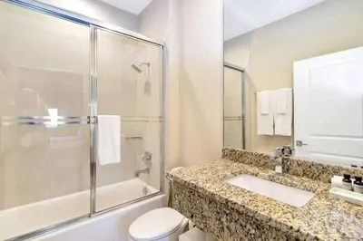 a bathroom with a shower and a toilet and a sink at wish home disney (45437492) in Orlando
