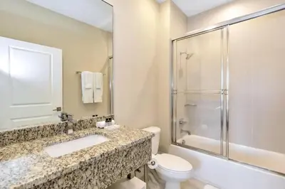 a bathroom with a sink and a toilet and a shower at Disney Dream Home (7662508) in Orlando