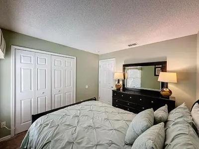 a bedroom with a large bed and a television at Four Bed in Emerald Island Resort mins to Disney in Kissimmee