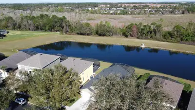 an aerial view of a house and a lake at Four Bed in Emerald Island Resort mins to Disney in Kissimmee