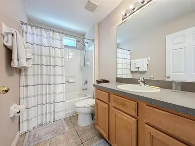 a bathroom with a sink and a toilet and a shower at Five Star Home Private Pool & Jaccuzzi*Free Wi-Fi* in Kissimmee