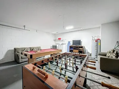 a living room with a ping pong table and a ping pong table at Five Star Home Private Pool & Jaccuzzi*Free Wi-Fi* in Kissimmee