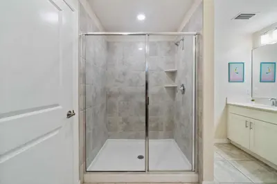 a shower with a glass door in a bathroom at 3120 Paradox Circle 104 in Kissimmee