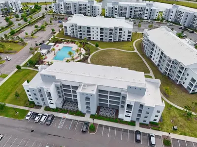 an aerial view of a apartment complex with a pool at 3120 Paradox Circle 104 in Kissimmee